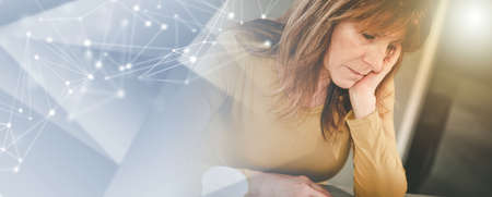Exhausted businesswoman sitting at desk; panoramic banner
