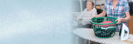Home help concept for an elderly woman; panoramic bannerの写真素材