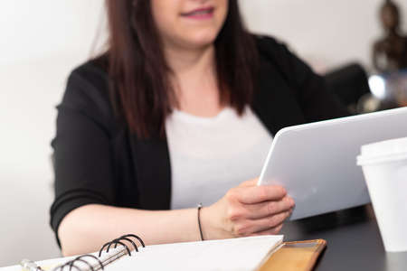 Businesswoman using digital tablet at workplace