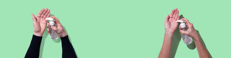 Hands using sanitizer bottle dispenser for coronavirus preventive measure on light green background; top viewの写真素材