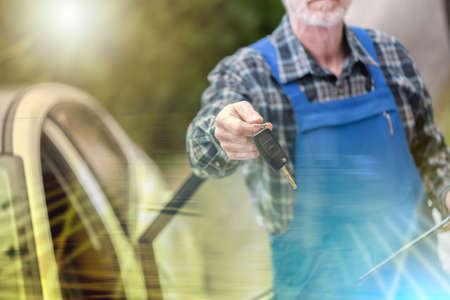Car mechanic delivering car keys after car engine checking; multiple exposure