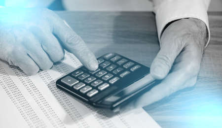 Male hands using calculator. concept of finance and economy; light effect