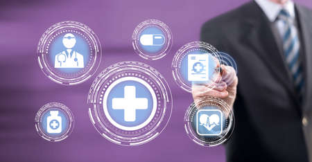 Man touching a healthcare concept on a touch screen with a stylus pen