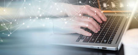 Female hands working on laptop in office; panoramic bannerの写真素材