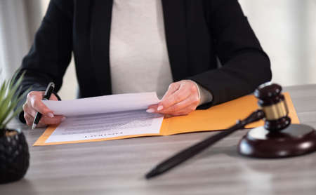 Female lawyer working on document. Legal, advice and justice concept