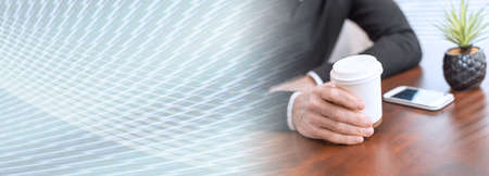 Man having coffee break at home; panoramic bannerの写真素材