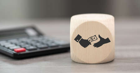 Wooden block with symbol of money transfer concept and calculator on background