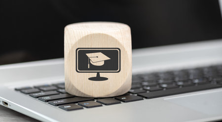 Wooden block with symbol of mooc concept on laptop keyboardの写真素材