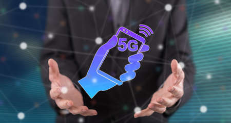 5g concept above the hands of a man in backgroundの写真素材
