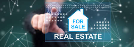 Man touching a real estate concept on a touch screen with his fingerの写真素材