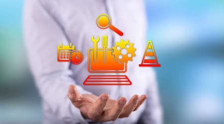 System maintenance concept above the hand of a man in background