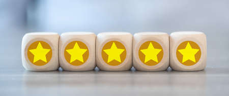 Concept of evaluation with stars on wooden cubesの写真素材