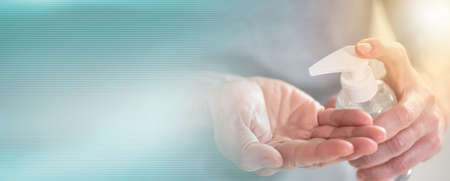 Hand pressing on sanitizer alcohol gel bottle; prevention of virus and bacteria infection; panoramic...