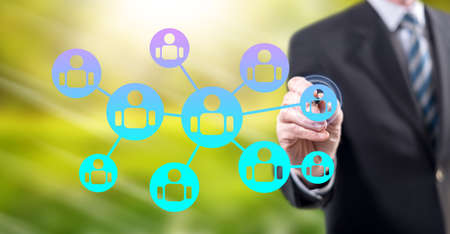 Man touching a social network concept on a touch screen with a stylus pen