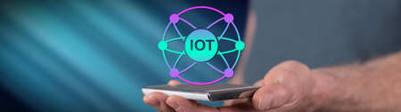 Iot concept above a smartphone held by a man