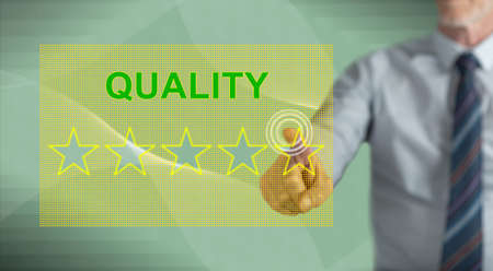 Man touching a quality concept on a touch screen with his finger