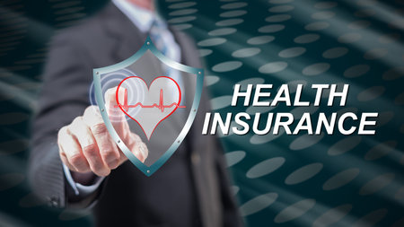 Man touching a health insurance concept on a touch screen with his fingersの写真素材