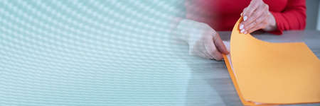 Businesswoman opening folder with paper documents; panoramic bannerの写真素材