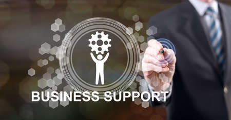 Man touching a business support concept on a touch screen with a stylus penの写真素材