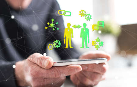 Hands of man holding a smartphone with business relationship concept
