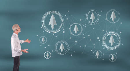 Businessman showing a start up concept on a wall screen