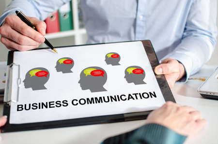 Businessman showing business communication concept on a clipboardの写真素材