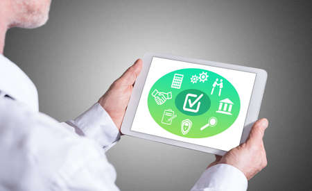 Man holding a tablet showing validation concept