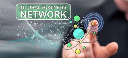 Man touching a global business network concept on a touch screen with his finger