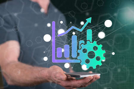 Productivity concept above a smartphone held by a man in backgroundの写真素材