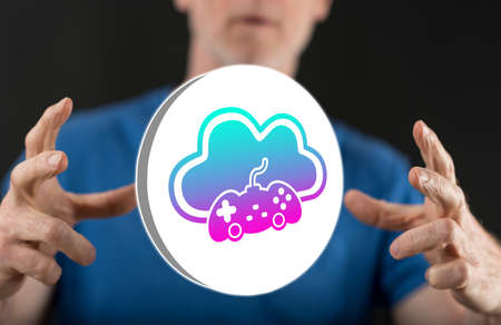 Cloud gaming concept between hands of a man in backgroundの写真素材