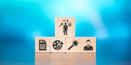 Wooden blocks with symbol of financial audit concept on blue backgroundの写真素材