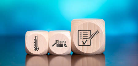 Wooden blocks with symbol of assessment concept on blue background