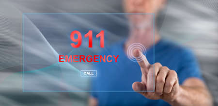 Man touching an emergency concept on a touch screen with his fingerの写真素材