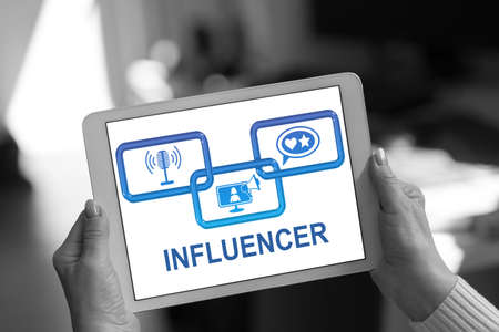 Influencer concept shown on a tablet held by a womanの写真素材