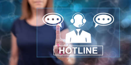 Woman touching a hotline concept on a touch screen with her fingerの写真素材