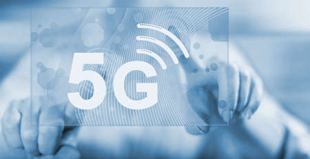 Woman touching a 5g concept on a touch screen with her fingers