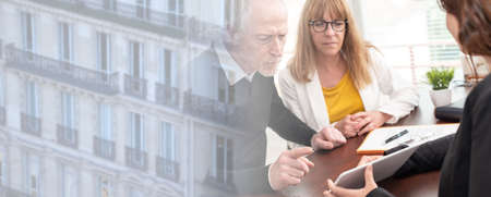 Senior couple meeting financial adviser for investment; panoramic banner