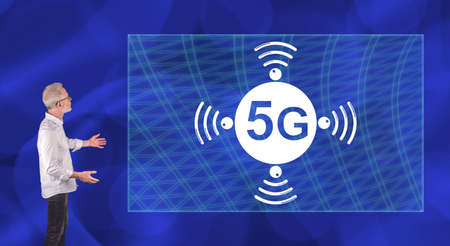 Businessman showing a 5g concept on a wall screen
