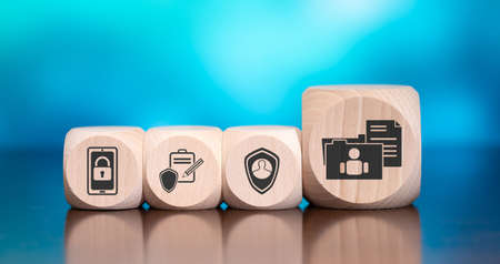 Wooden blocks with symbol of personal data concept on blue backgroundの写真素材