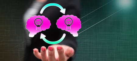 Knowledge sharing concept above the hand of a woman in background