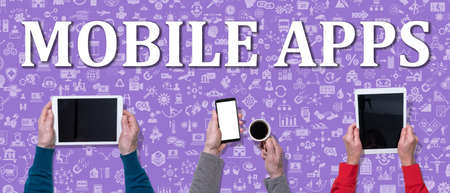 Mobile apps concept with top view of hands using mobile phone and digital tablet on icons backgroundの写真素材