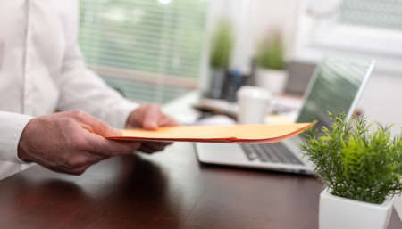 Businessman holding folder with paper documents