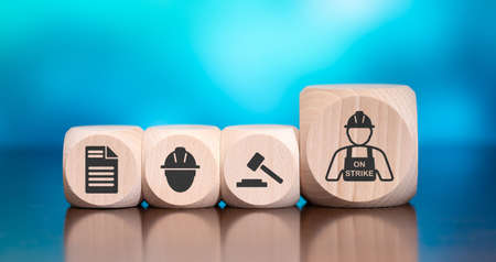 Wooden blocks with symbol of strike concept on blue backgroundの写真素材