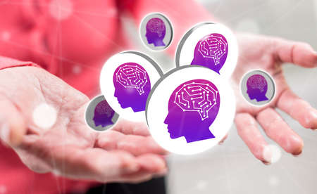 Artificial intelligence concept above the hands of a woman in backgroundの写真素材