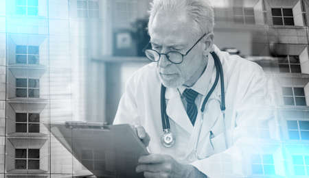 Senior doctor reading a clinical record in medical office; multiple exposure