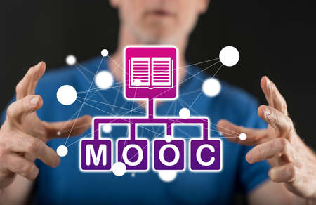 Mooc concept between hands of a man in backgroundの写真素材