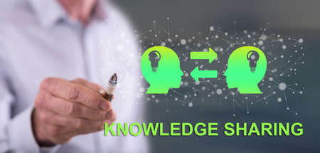 Man touching a knowledge sharing concept on a touch screen with a penの写真素材