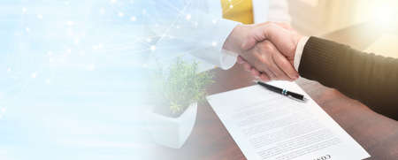 Businesswoman and businessman shaking hands (lorem ipsum text used); panoramic bannerの写真素材