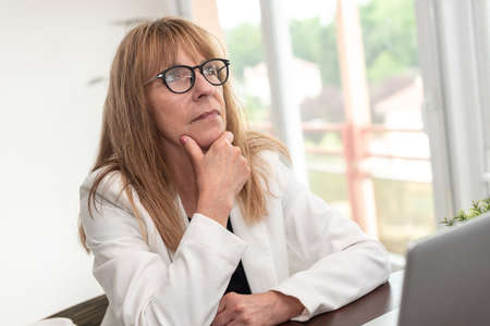 Portrait of thoughtful mature businesswoman at office
