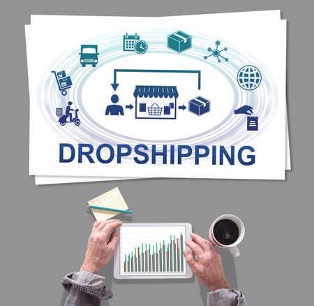Male hands using tablet in front of dropshipping conceptの写真素材